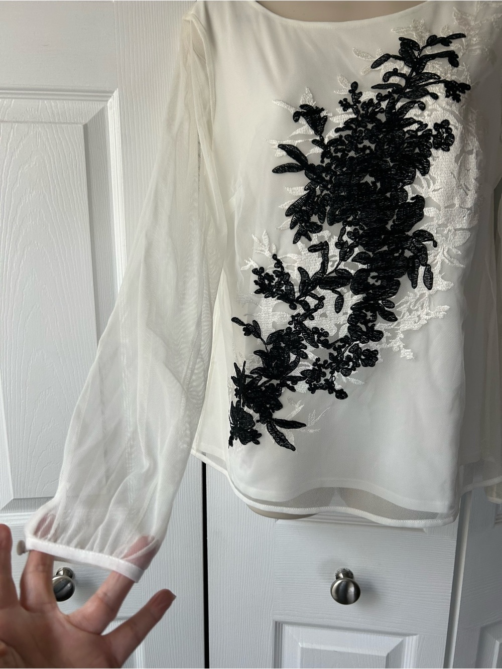 Elegant White Sheer Long-Sleeve Top with Black Floral Applique